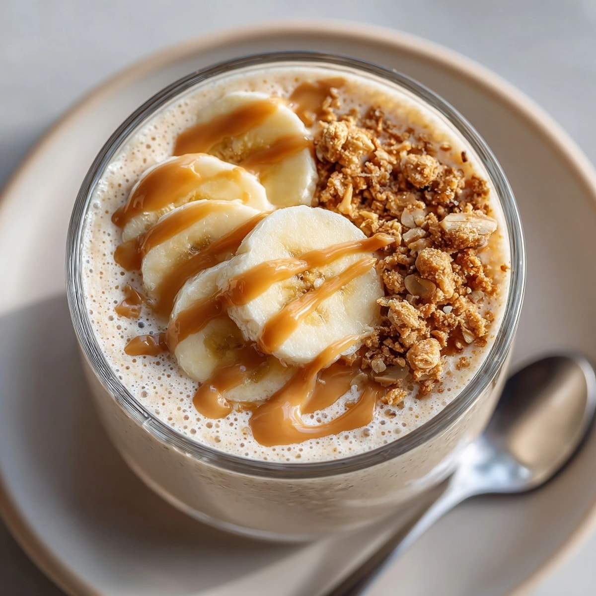 Thick, frosty peanut butter banana smoothie with yogurt, ideal for a protein-packed American snack.