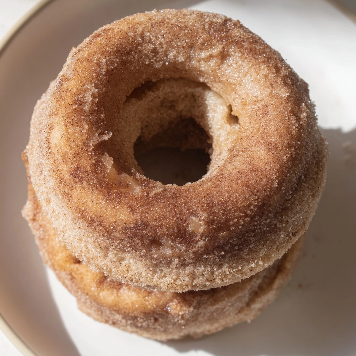 Golden brown Baked Apple Cider Donuts fresh from the oven, ready for coating.