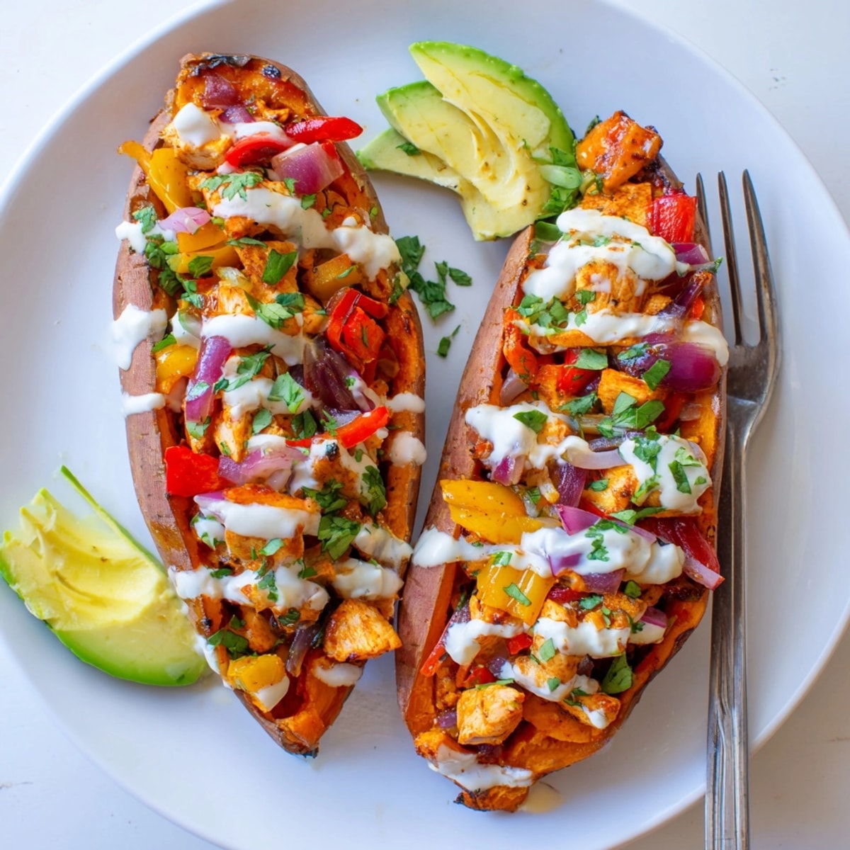 Close-up of Cajun Chicken Sweet Potato Boats, bright bell peppers & creamy yogurt.
