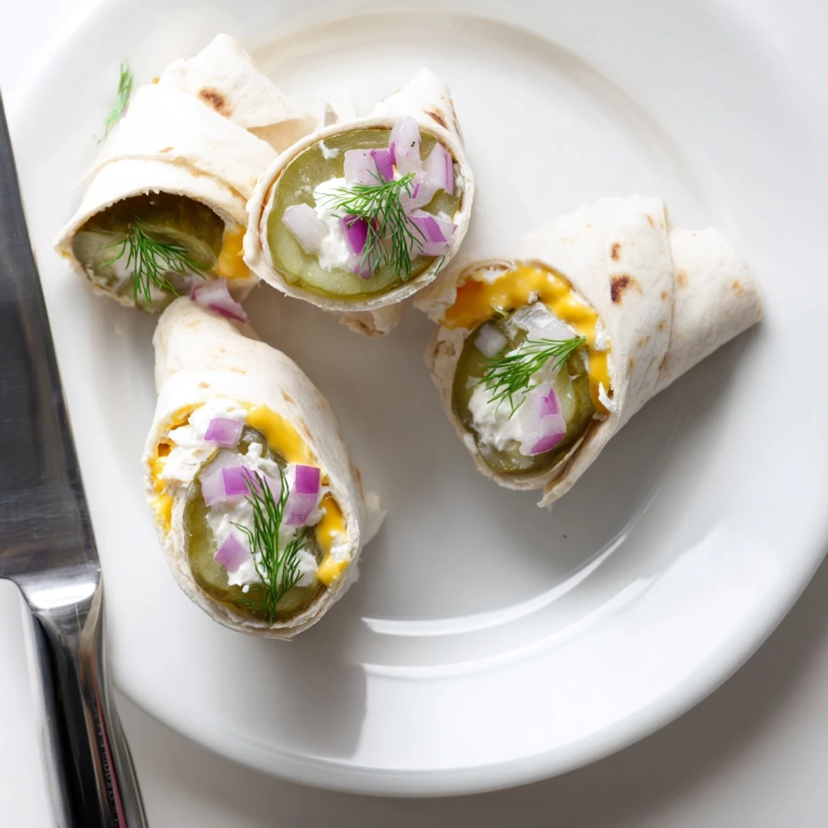 Crispy pickle-in-a-blanket bites with creamy cheese, perfect for party snacking.  