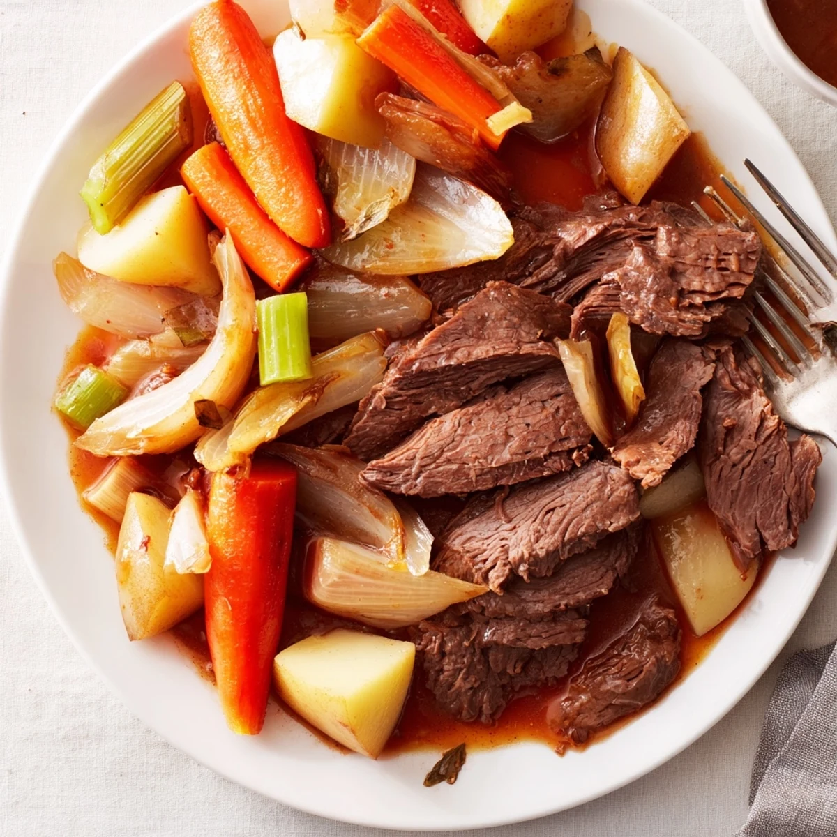 Savory Sunday pot roast served with caramelized roasted veggies, ideal for gatherings.