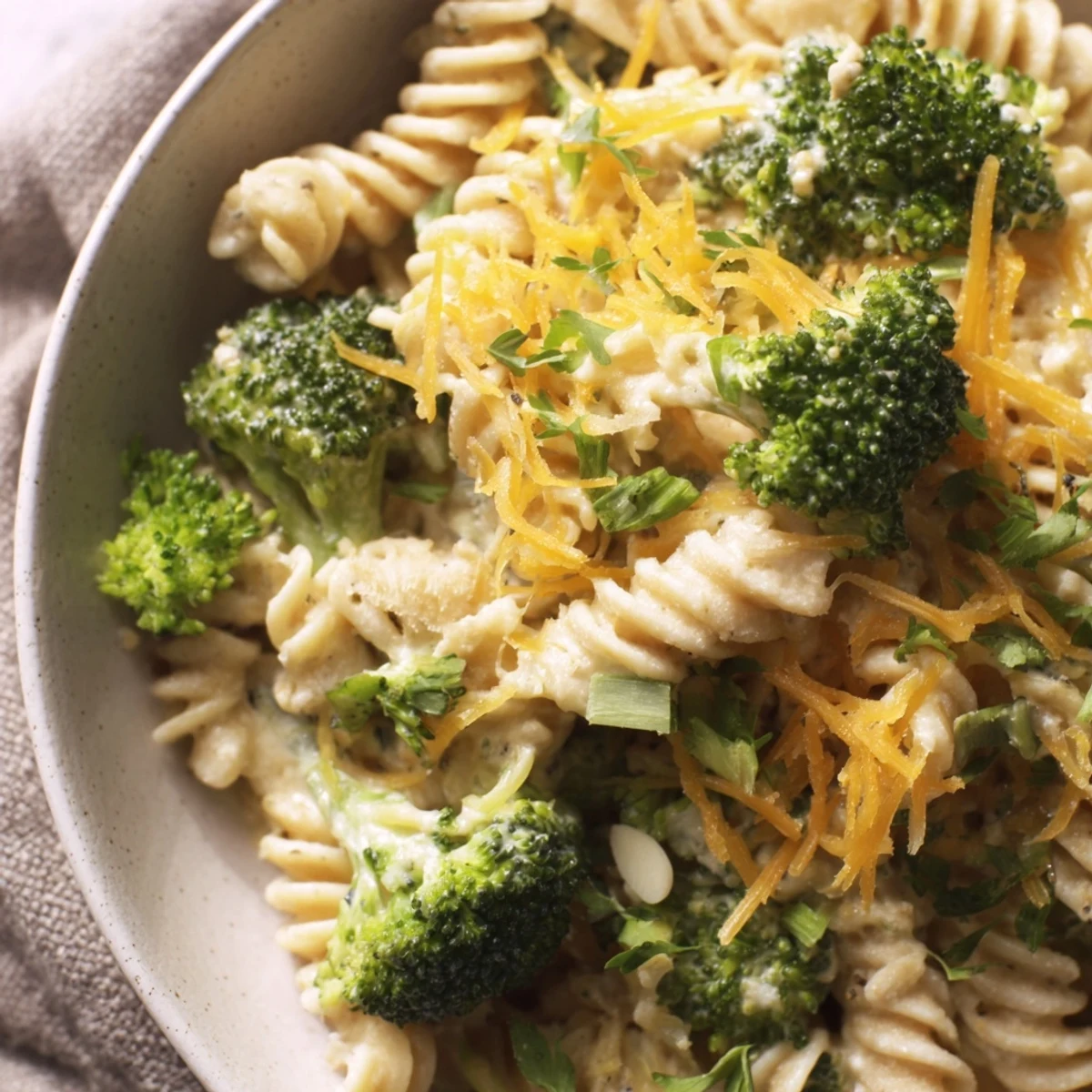 Creamy Green Goddess Broccoli Cheddar One-Pot Pasta with vibrant herbs and melted cheddar, ready to serve.