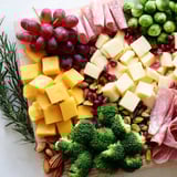 This visually stunning Evergreen Tree Snack Board showcases a variety of textures and flavors ready for guests to enjoy.