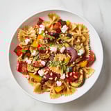 Freshly tossed Festive Bow Tie Pasta, bright with lemon dressing and herbs, ready to serve with wine.