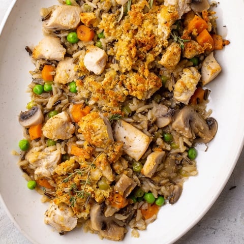 Golden brown Chicken and Wild Rice Bake, bubbling with a creamy sauce and cheesy top layer.