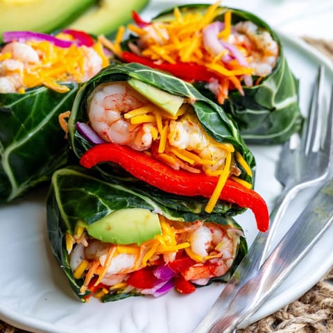 Close-up of Shrimp & Cheddar Collard Green Wraps showing colorful filling and tight roll.