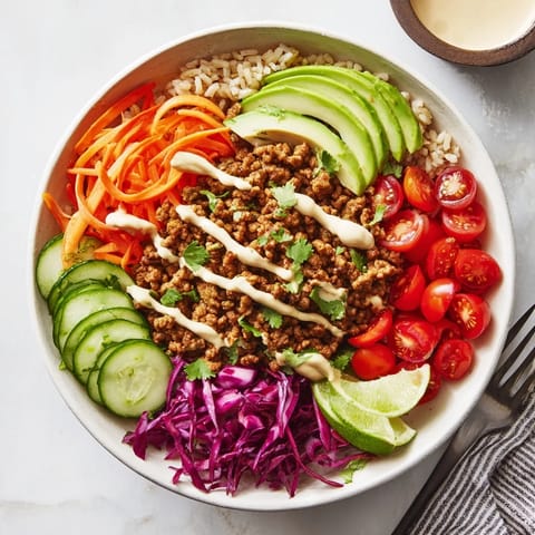 Colorful ingredients in a plant-based meat bowl with healthy toppings and lime.  