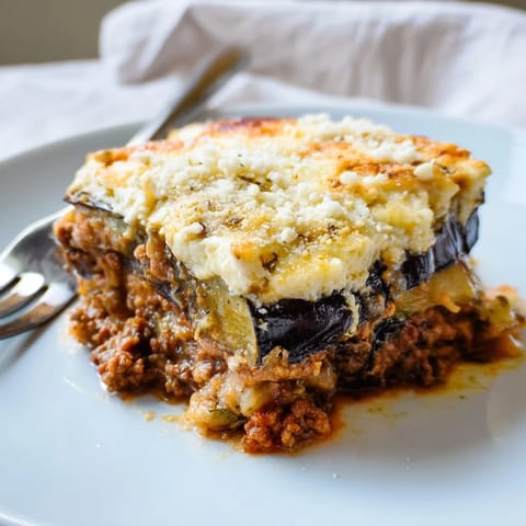 Savory Moussaka with Beef & Eggplant, topped with golden, creamy béchamel sauce.  