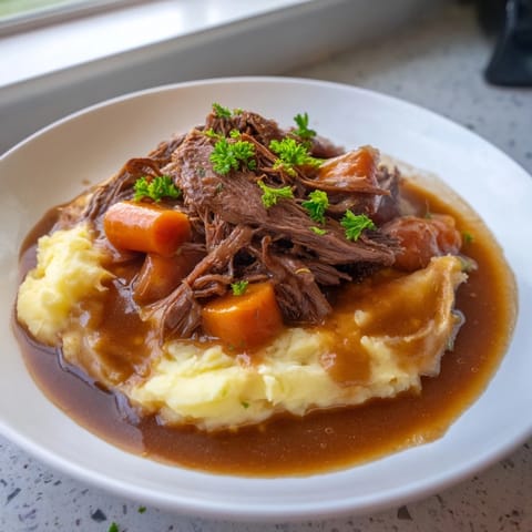 Fork-tender Slow Cooker Pot Roast, glistening with rich gravy, ready to be served.