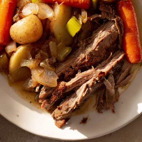 This delicious Pickle Brine Pot Roast displays juicy beef and tender root vegetables, ready to serve with crusty bread.