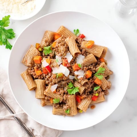 Close-up of the flavorful High-Fiber Lentil Bolognese, bubbling and rich, ready to coat the pasta.