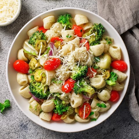 Steaming bowl of ditalini pasta with air-fried vegetables, ready for a delicious vegetarian meal.