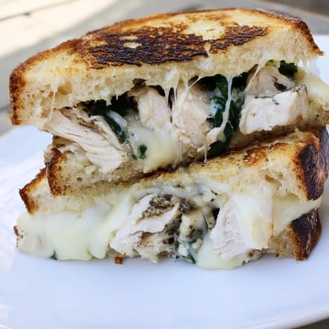 Savory Grilled Chicken Spinach Panini served hot, revealing juicy chicken and melted cheese in each bite.