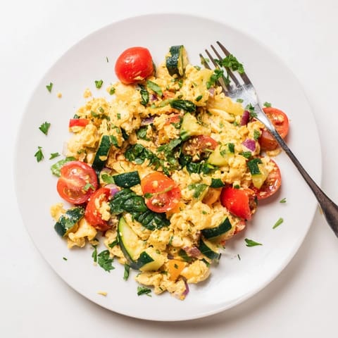 This colorful Egg and Vegetable Scramble features soft scrambled eggs with zucchini, red onion, and fresh herbs.  