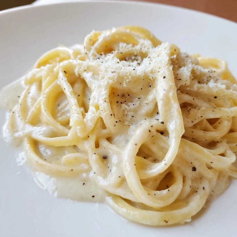 Freshly grated Parmesan atop the buttery, delicious Lazy Girl Three-Ingredient Pasta, a quick weeknight meal.