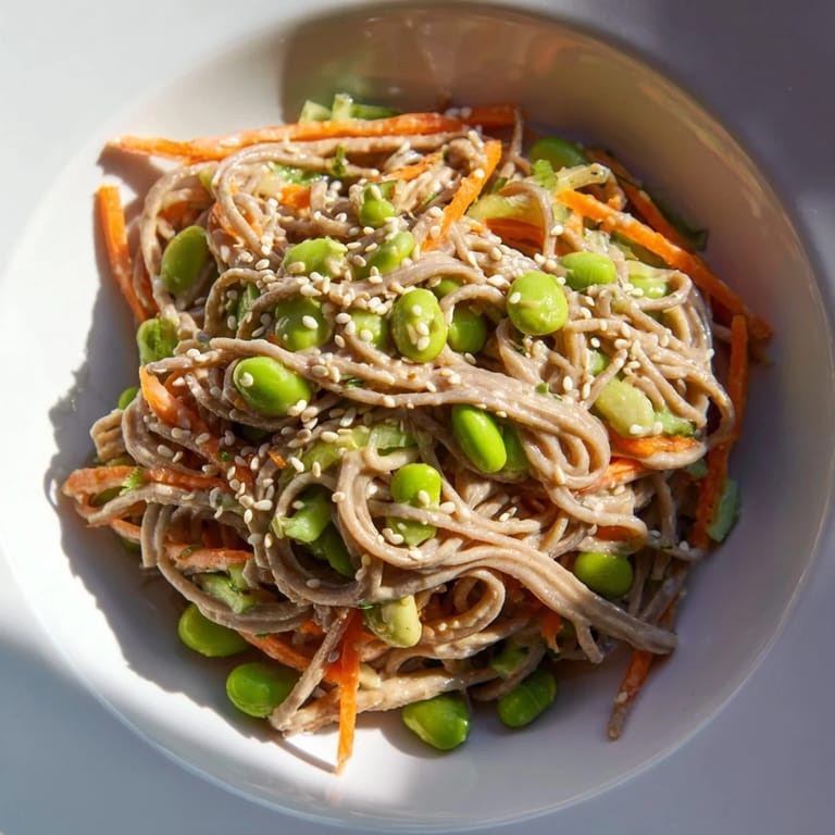 Close-up of a creamy, delicious Asian Sesame Noodle Salad, showcasing fresh vegetables and savory dressing.