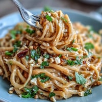Vibrant Thai Peanut Noodle Salad with crisp vegetables, fresh herbs, and creamy lime-infused peanut sauce—perfect for a light, refreshing meal.